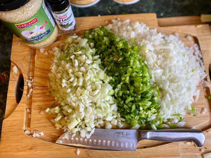 Chopped celery, bell pepper and onion on a cutting board